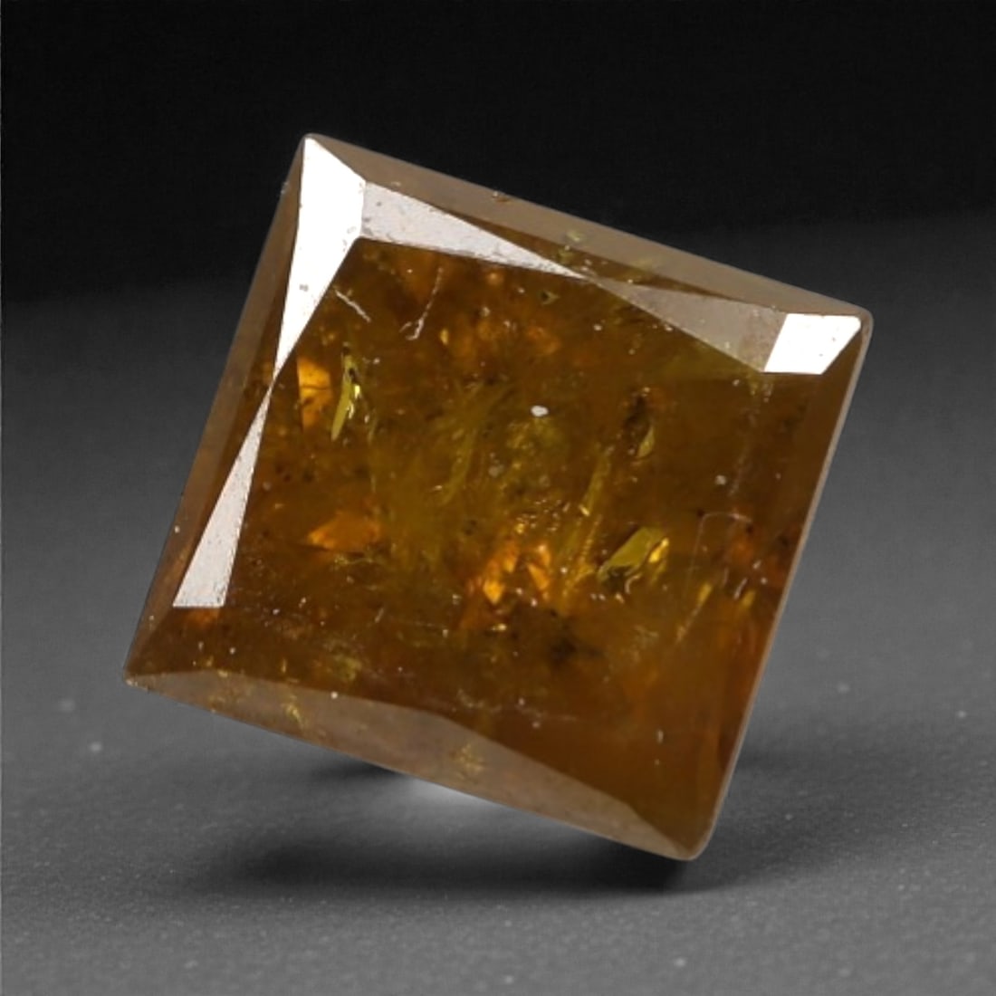 0.22 Carats Orangy Red Fancy Diamond - Princess Cut, 192A: This rare fancy orangy red diamond captivates with a vivid, warm hue that evokes the intensity of a glowing ember and the richness of a sunset. Cut in a well-proportioned princess shape, the stone's f