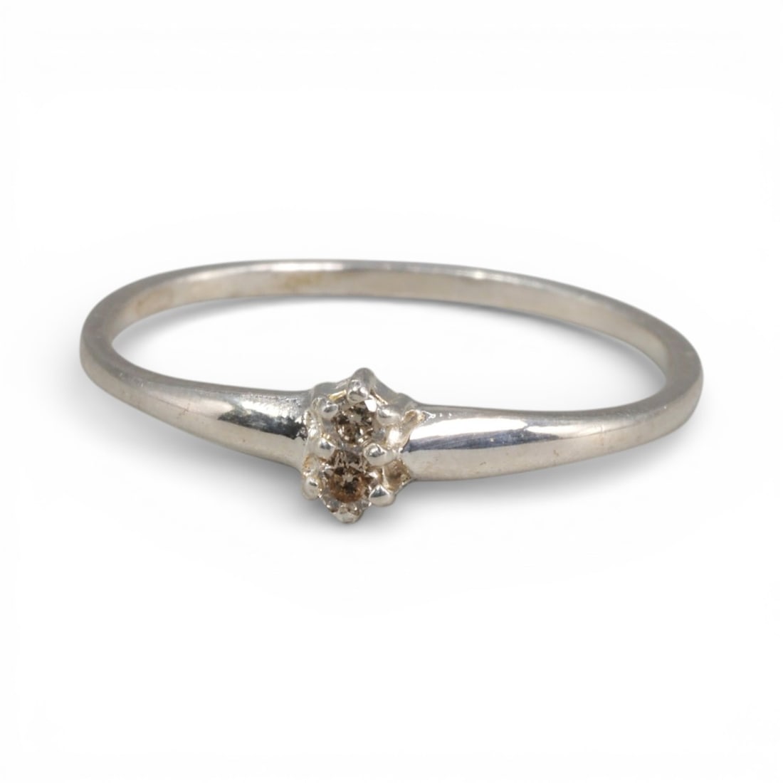 Sterling Silver (925) Ring with Two Champagne Diamonds - Size 6 US, 137A: This delicate ring is crafted from polished sterling silver, featuring a slender, tapered band that culminates in a dual-stone setting. The design centers on two small, round-cut champagne diamonds, h