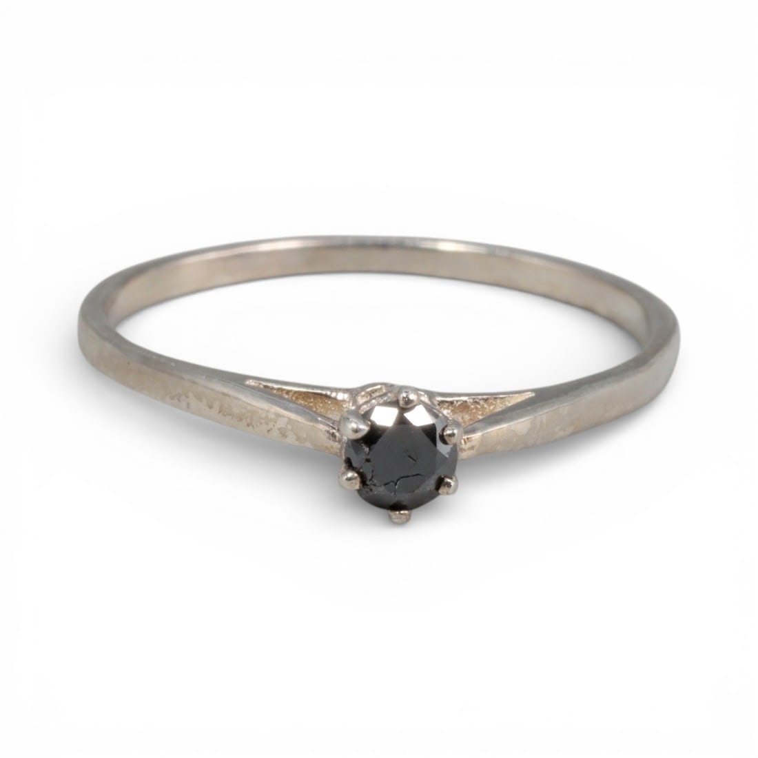 Sterling Silver (925) Ring with Black Diamond - Size 6.5 US, 135A: This elegant ring is crafted from polished sterling silver, featuring a slender, tapered band that culminates in a classic four-prong setting. The centerpiece is a round-cut black diamond, whose deep,