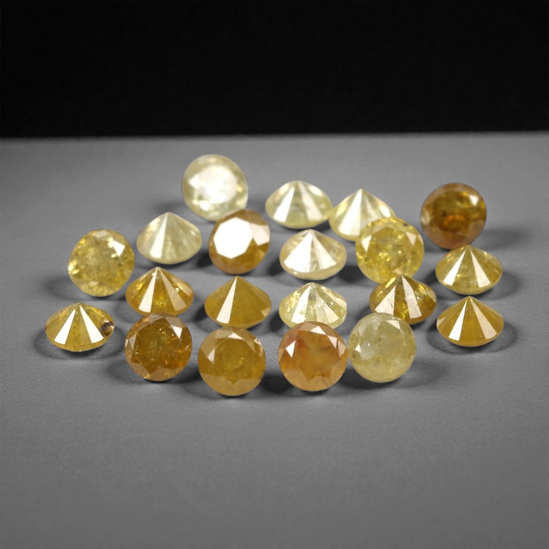 1.02 Carats Fancy Yellow Diamond Parcel - Natural African Stones, 47A: This exquisite parcel of round fancy diamonds radiates with a warm, honeyed glow, ranging from soft lemon and buttercup hues to deeper golden amber tones. Each stone is precision-cut to maximize light