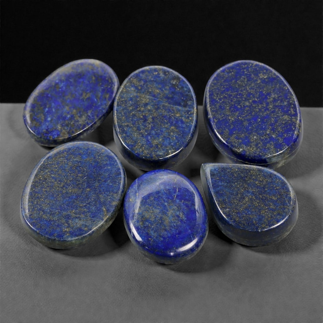 259.92 Carats Royal Blue Lapis Lazuli Lot - Natural Afghan Stones, 27-33mm, 17XK: This commanding lot of lapis lazuli showcases the deep royal blue that has captivated artists and collectors for centuries. Interspersed with fine golden pyrite flecks and traces of calcite, each ston