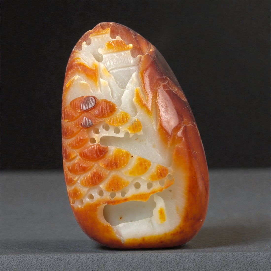 A Chinese Nephrite Jade Landscape Pebble Carving, 20th Century, 34FB: Carved from a Hetian nephrite jade pebble retaining areas of natural russet skin contrasting with the pale, translucent interior, the carving is worked in relief to depict a stylized landscape scene.