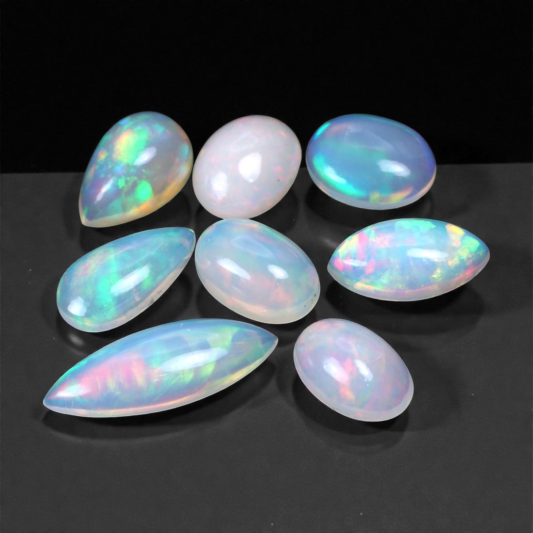 18.77 Carats Iridescent Crystal Opal Parcel - Natural Ethiopian Stones, 10-21mm, 79XH: This glowing parcel of natural crystal opals showcases an exceptional range of pastel body tones illuminated by brilliant internal fire. Soft translucent bases come alive with flashes of lime green, e