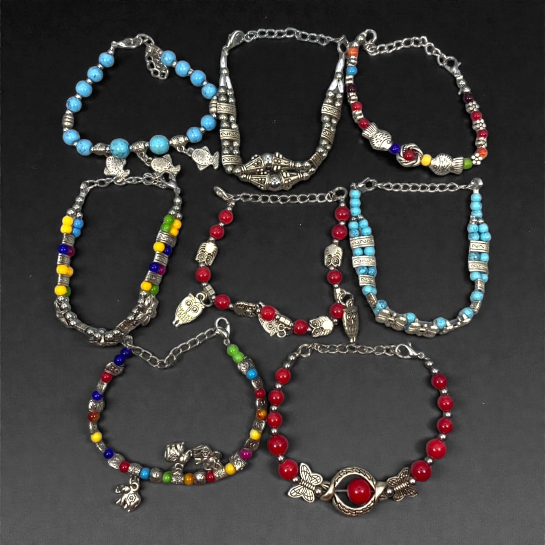 A Group of Eight Silver-Tone and Beaded Bracelets, Late 20th-Early 21st Century, 40ZG: The group comprises eight bracelets assembled from silver-tone metal components and assorted colored beads, including spherical and cylindrical examples in blue, red, yellow, green, black, and multico