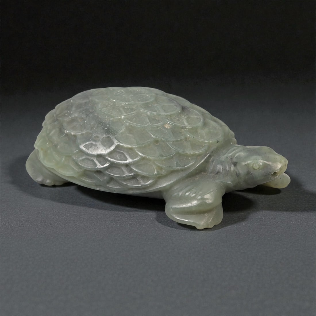 A Chinese Nephrite Jade Turtle Figure, 20th Century, 95YA: Carved from pale green nephrite jade with areas of soft translucency and minor natural inclusions, the figure represents a turtle shown in a naturalistic, recumbent posture. The domed carapace is care