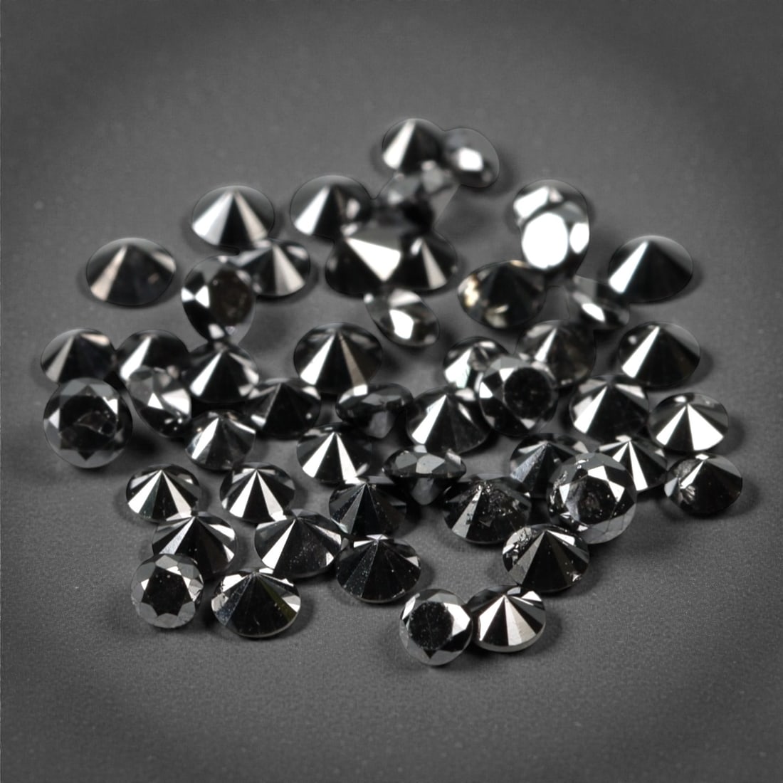 50 Pieces Black Diamond Parcel - Round Brilliant Cut, 1.7mm, 165A: This versatile parcel of 50 loose black diamond gems captivates with a deep, opaque black hue that evokes the intensity of polished obsidian and the mystery of a midnight sky. Each stone is cut in a w