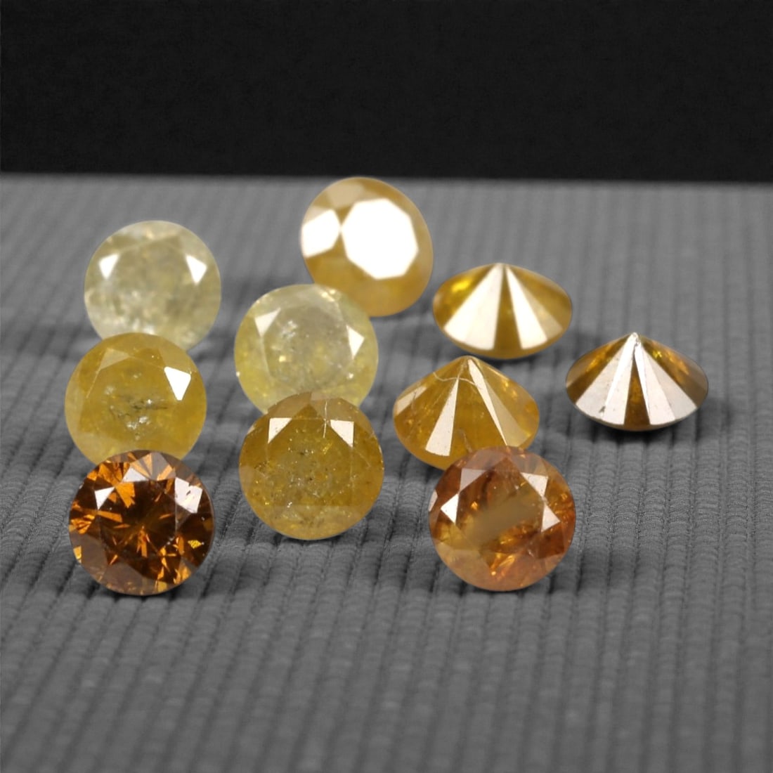 0.74 Carats Fancy Yellow Diamond Parcel - Natural African Stones, 44A: This exquisite parcel of round fancy diamonds radiates with a warm, honeyed glow, ranging from soft lemon and buttercup hues to deeper golden amber tones. Each stone is precision-cut to maximize light
