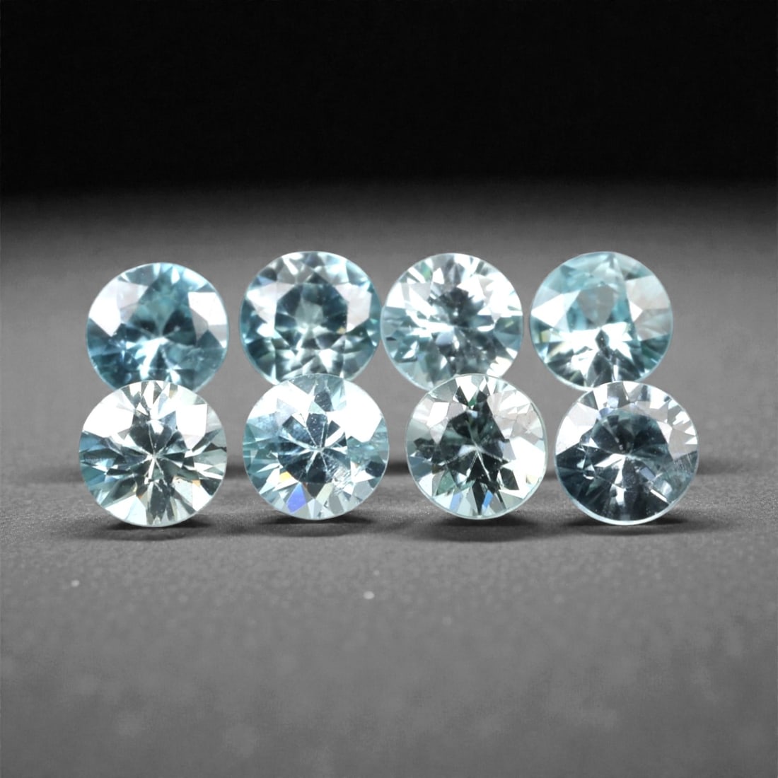 3.08 Carats Sky Blue Zircon Selection - Natural Cambodian Stones, 314A: This curated selection of eight round-cut zircon gems presents a serene, sky-blue hue, reminiscent of clear tropical waters and open summer skies. Each stone is precision-faceted to maximize light dis