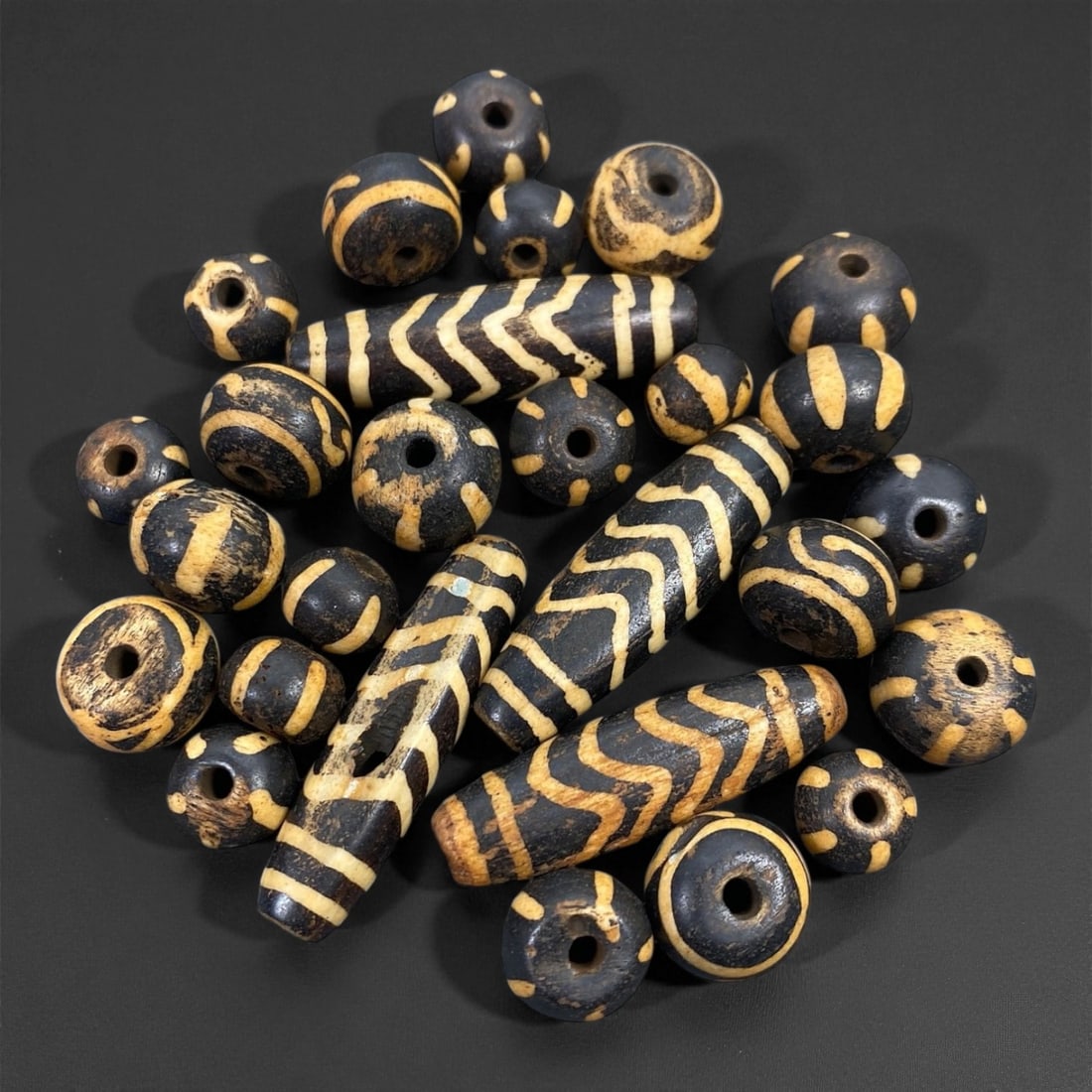 Antique Pyu-Style Pumtek Wood Beads Set, c. 19th Century 1.1-4cm, 26XE: This set of antique pumtek wood beads, ranging from 1.1 to 4 cm, reflects the enduring beadworking traditions of Burma, where pumtek beads have long been associated with prestige, spiritual protection