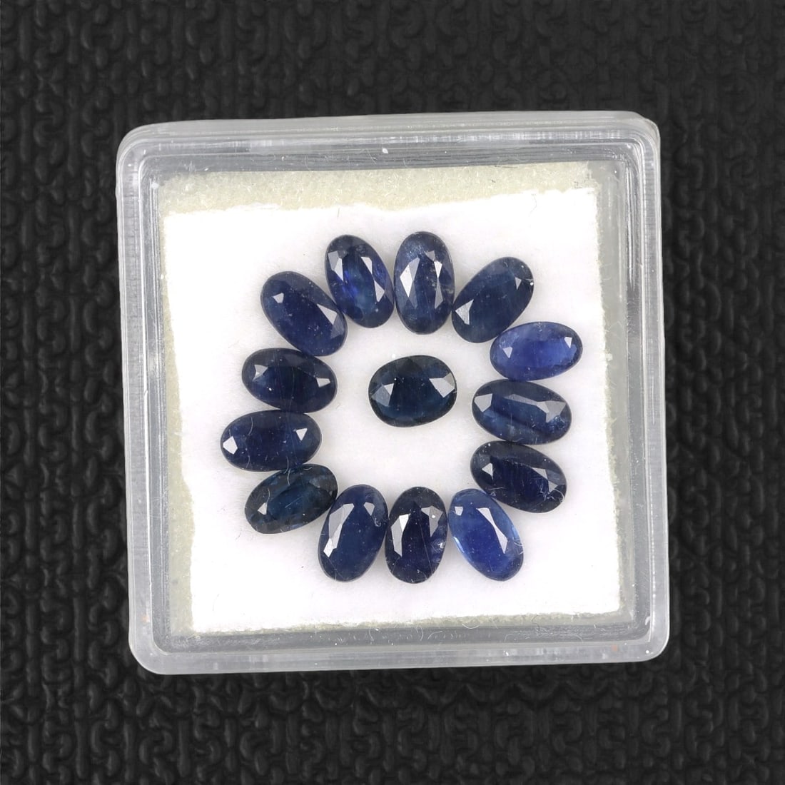 4.56 Carats Australian Blue Sapphire Parcel - Oval Cut, 94DA: This curated parcel of oval-cut blue sapphires from Australia exhibits a rich, deep blue hue, reminiscent of the ocean at midnight. Each stone is precision-cut to maximize light return, creating a spa