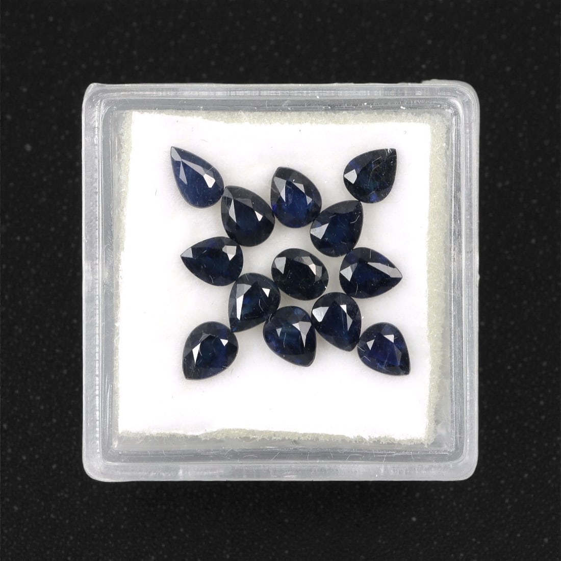4.07 Carats Australian Blue Sapphire Parcel - Pear Cut, 83DA: This curated parcel of pear-cut blue sapphires from Australia exhibits a rich, deep blue hue, reminiscent of the ocean at midnight. Each stone is precision-cut to maximize light return, creating a spa