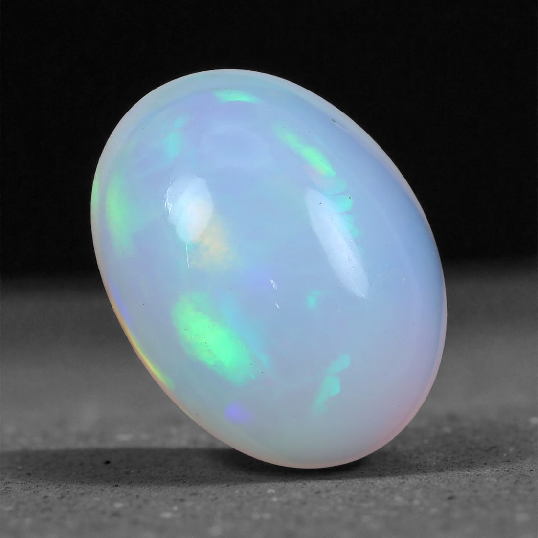 5.64 Carats Mint Glow Welo Opal - Natural Ethiopian Gemstone 14.4x10.7x6.3mm, 48XH: This striking Welo opal glows with a soothing blend of cool mint green, soft aqua, and hints of pale gold that shift across its silky surface. The play-of-color is smooth and tranquil, with softly glo