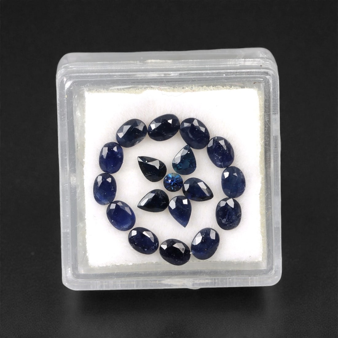 4.15 Carats Australian Blue Sapphire Parcel - Mixed Cut, 78DA: This curated parcel of mixed-cut blue sapphires from Australia exhibits a rich, deep blue hue, reminiscent of the ocean at midnight. The stones are precision-cut in a variety of shapes, including oval