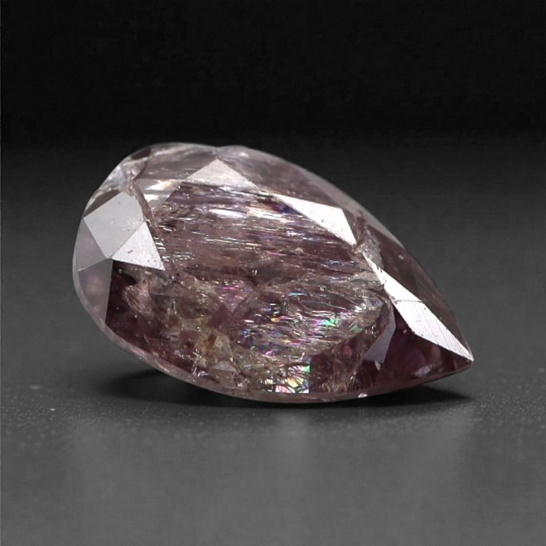 0.20 Carats Purplish Pink Diamond - Natural Argyle Mine, Australia, 104A: This singular purplish pink diamond from the Argyle mine is a rare and captivating gem, showcasing the distinctive, velvety hue that has made Australian pink diamonds among the most coveted in the wor