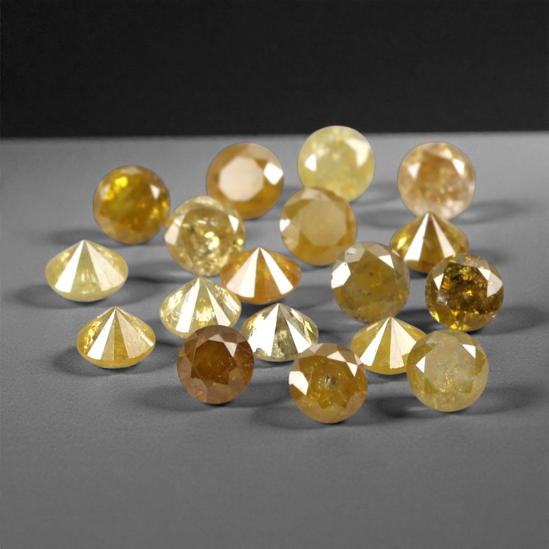 1.02 Carats Fancy Yellow Diamond Parcel - Natural African Stones, 43A: This exquisite parcel of round fancy diamonds radiates with a warm, honeyed glow, ranging from soft lemon and buttercup hues to deeper golden amber tones. Each stone is precision-cut to maximize light