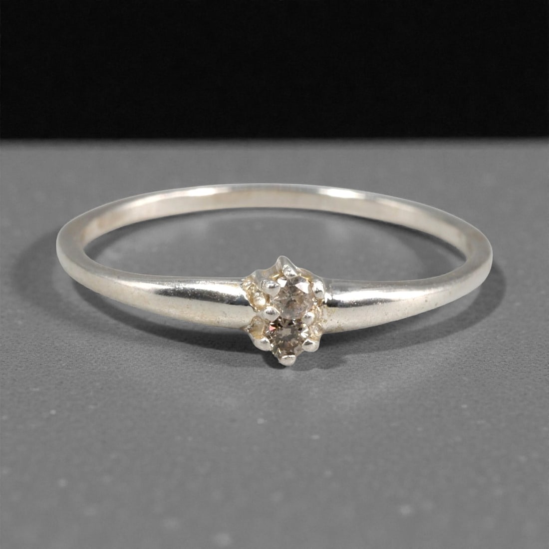 Sterling Silver (925) Ring with Two Champagne Diamonds - Size 6 US, 124A: This delicate ring is crafted from polished sterling silver, featuring a slender, tapered band that culminates in a dual-stone setting. The design centers on two small, round-cut champagne diamonds, h
