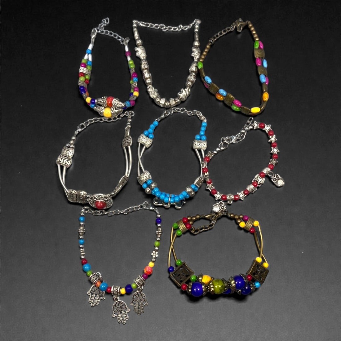 A Group of Eight Silver-Tone and Beaded Bracelets, Late 20th-Early 21st Century, 38ZG: The group comprises eight bracelets assembled from silver-tone metal components and assorted colored beads, including spherical and cylindrical examples in blue, red, yellow, green, pink, and multicol