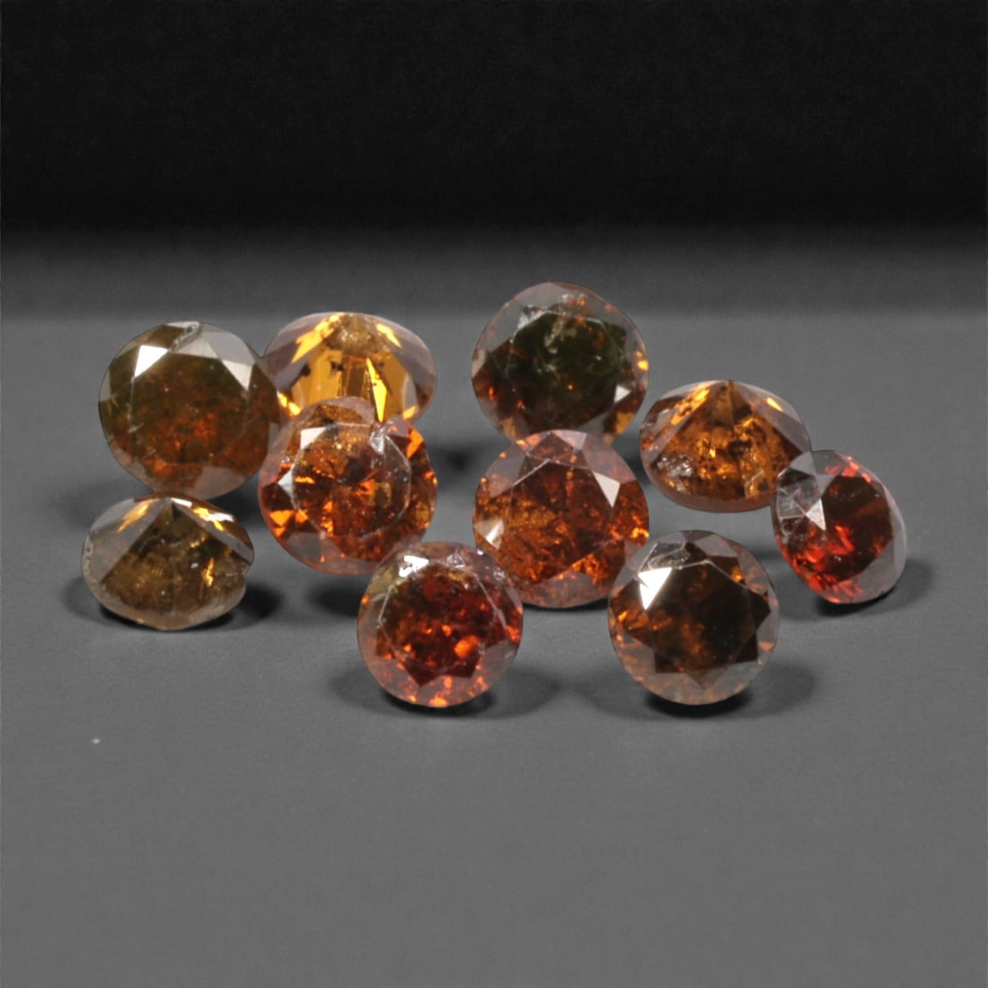 10 Pieces Irradiated Red Diamond Parcel - Round Brilliant Cut, 1.6-1.7mm, 275A: This vibrant parcel of 10 loose irradiated red diamond gems captivates with a rich, fiery red hue that evokes the intensity of a glowing ember and the warmth of a sunset. Each stone is cut in a well-p