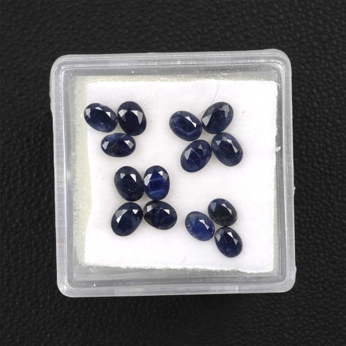 3.48 Carats Australian Blue Sapphire Parcel - Oval Cut, 74DA: This curated parcel of oval-cut blue sapphires from Australia exhibits a rich, deep blue hue, reminiscent of the ocean at midnight. Each stone is precision-cut to maximize light return, creating a spa