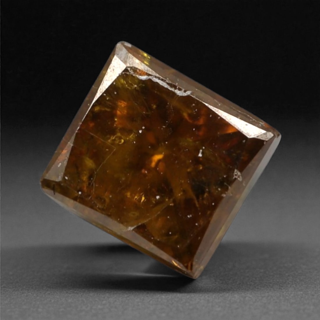0.39 Carats Orangy Red Fancy Diamond - Princess Cut, 195A: This rare fancy orangy red diamond captivates with a vivid, warm hue that evokes the intensity of a glowing ember and the richness of a sunset. Cut in a well-proportioned princess shape, the stone's f