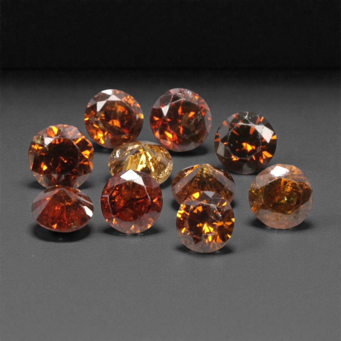 10 Pieces Irradiated Red Diamond Parcel - Round Brilliant Cut, 1.6-1.7mm, 272A: This vibrant parcel of 10 loose irradiated red diamond gems captivates with a rich, fiery red hue that evokes the intensity of a glowing ember and the warmth of a sunset. Each stone is cut in a well-p