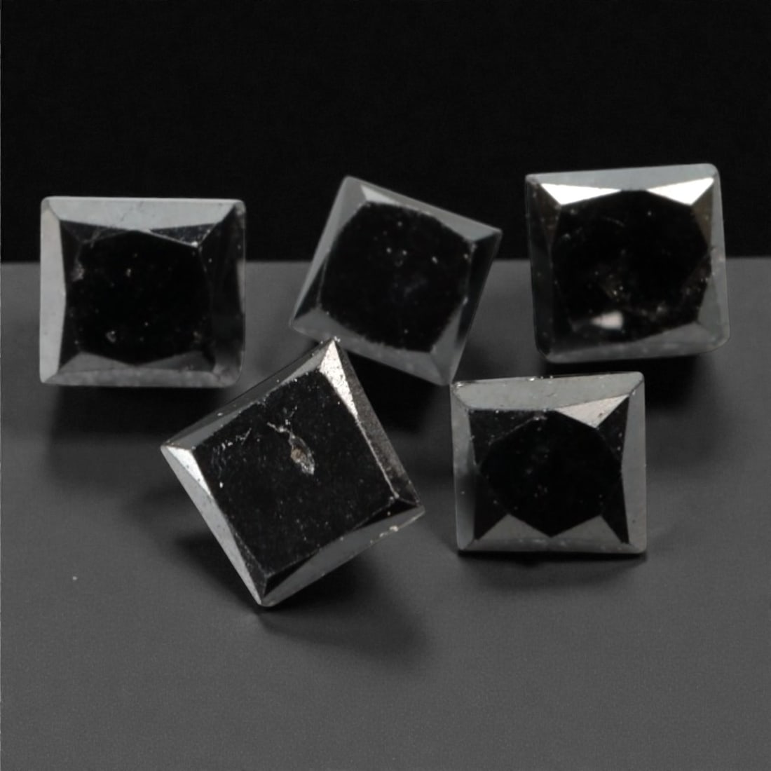 0.90 Carats Black Diamond Parcel - Princess Cut, 234A: This striking parcel of five loose black diamond gems captivates with a deep, opaque black hue that evokes the intensity of polished obsidian and the mystery of a midnight sky. Each stone is cut in a