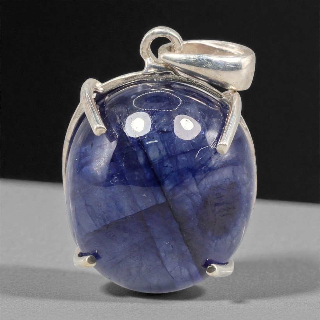 15.87 Carats Deep Blue Sapphire Cabochon Pendant - Sterling Silver Setting, 149A: This striking pendant features a substantial deep blue sapphire cabochon, set in a polished sterling silver frame stamped 925. The cabochon's smooth, domed surface radiates with a rich, velvety blue h