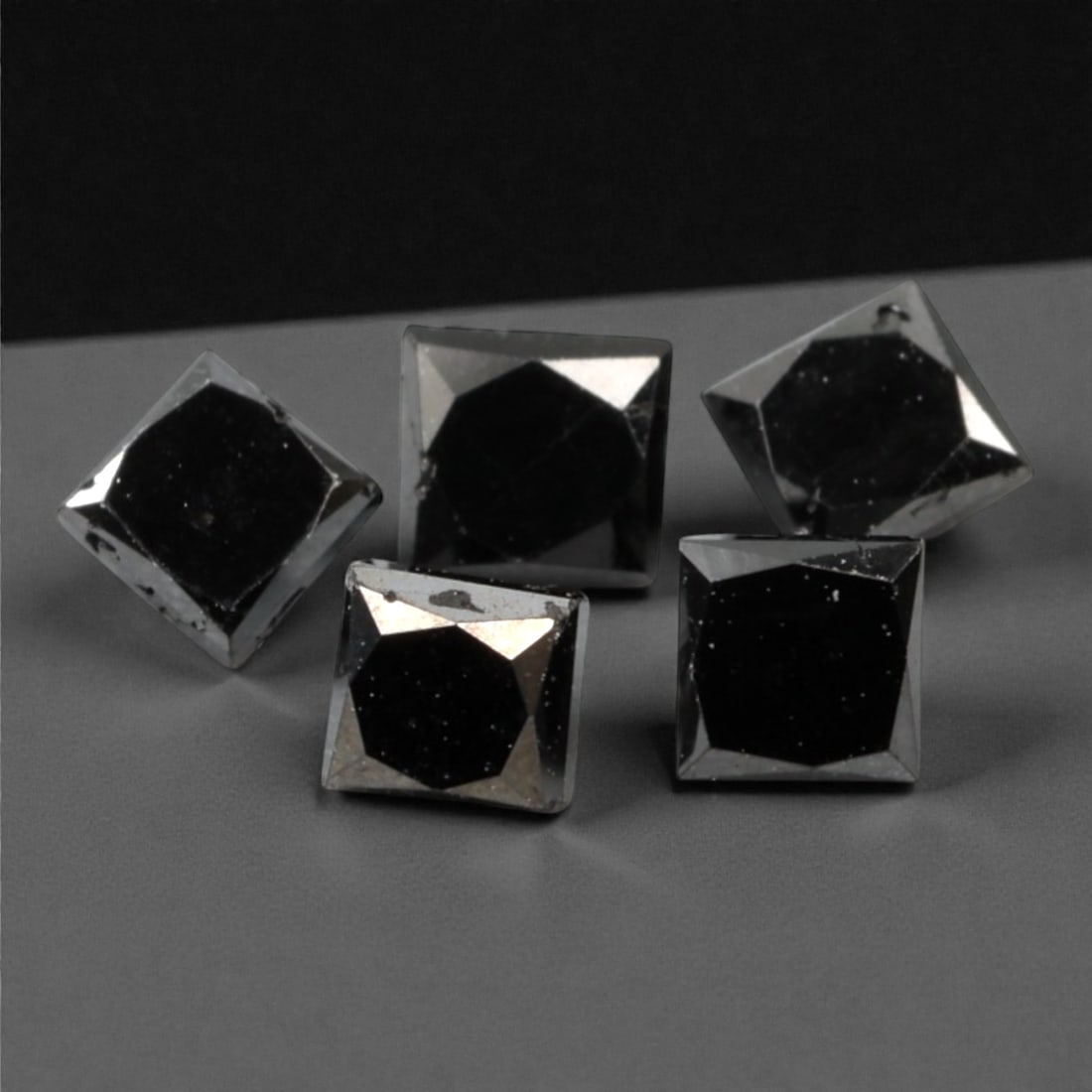 0.99 Carats Black Diamond Parcel - Princess Cut, 230A: This striking parcel of five loose black diamond gems captivates with a deep, opaque black hue that evokes the intensity of polished obsidian and the mystery of a midnight sky. Each stone is cut in a