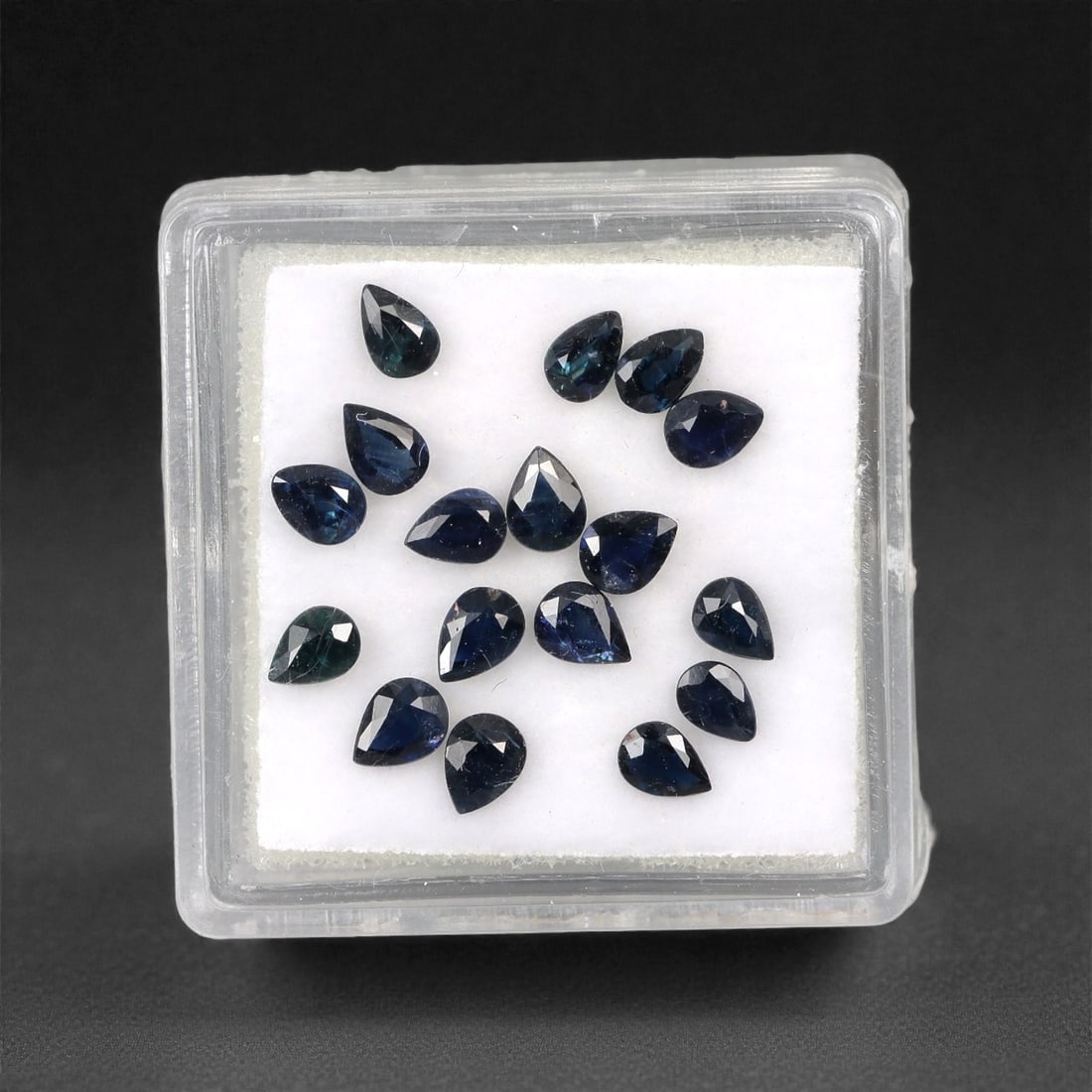 2.77 Carats Australian Blue Sapphire Parcel - Pear Cut, 72DA: This curated parcel of pear-cut blue sapphires from Australia exhibits a rich, deep blue hue, reminiscent of the ocean at midnight. Each stone is precision-cut to maximize light return, creating a spa