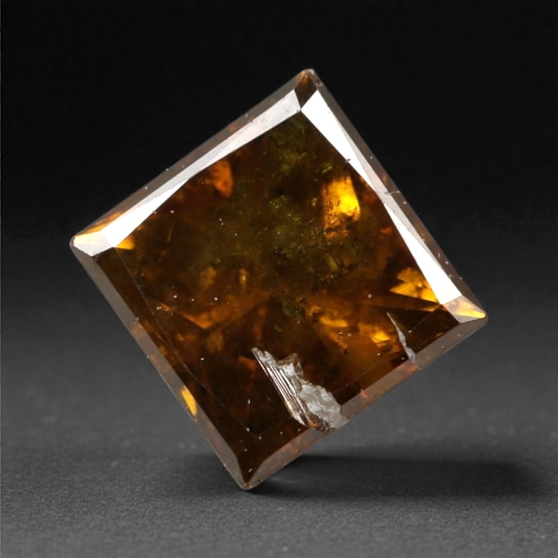 0.45 Carats Orangy Red Fancy Diamond - Princess Cut, 190A: This rare fancy orangy red diamond captivates with a vivid, warm hue that evokes the intensity of a glowing ember and the richness of a sunset. Cut in a well-proportioned princess shape, the stone's f