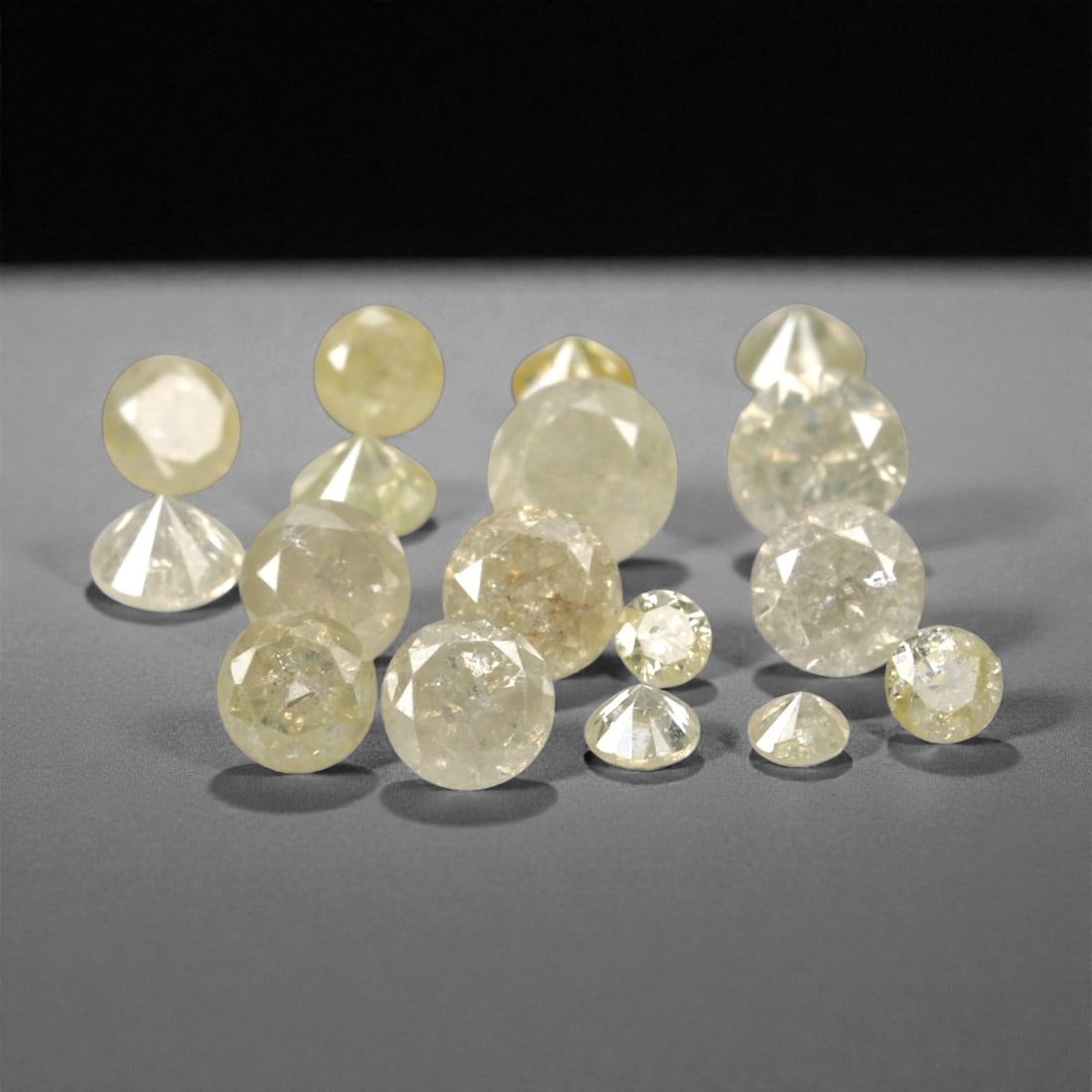1.00 Carats Fancy Yellow Diamond Parcel - Natural African Stones, 48A: This exquisite parcel of round fancy diamonds radiates with a warm, honeyed glow, ranging from soft lemon and buttercup hues to deeper golden amber tones. Each stone is precision-cut to maximize light