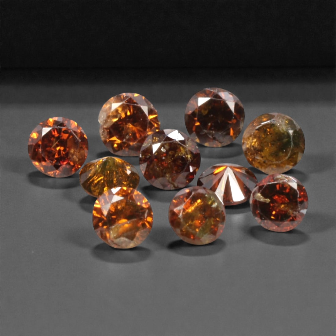 10 Pieces Irradiated Red Diamond Parcel - Round Brilliant Cut, 1.6-1.7mm, 277A: This vibrant parcel of 10 loose irradiated red diamond gems captivates with a rich, fiery red hue that evokes the intensity of a glowing ember and the warmth of a sunset. Each stone is cut in a well-p