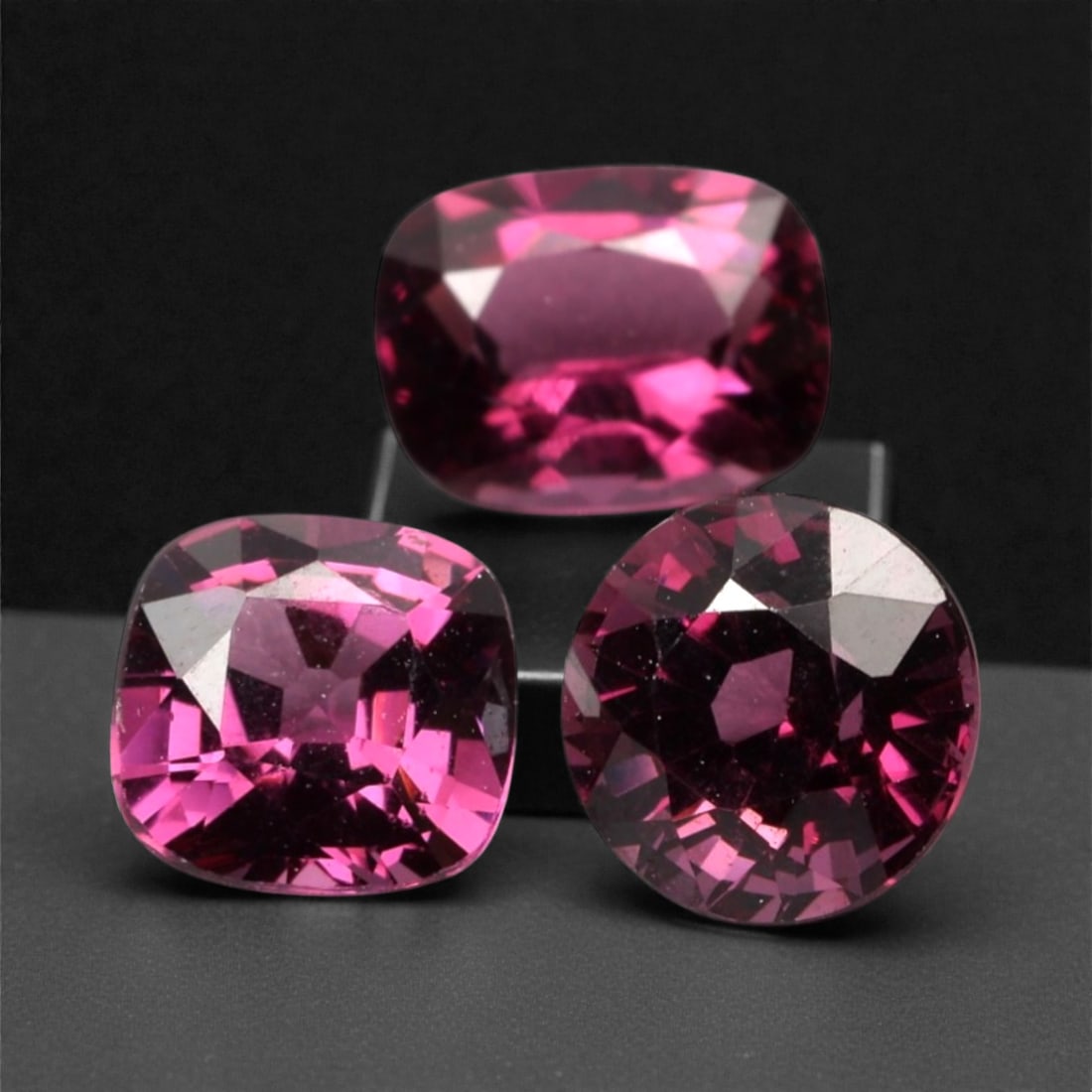 3.36 Carats Deep Raspberry Rhodolite Garnet Selection - Natural Mozambican Stones, 311A: This curated selection of three rhodolite garnets captivates with a deep, velvety raspberry hue, reminiscent of ripe summer berries and rich red wine. Each stone is precision-faceted to maximize light
