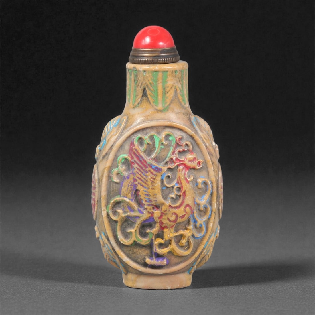 A Chinese Hardstone Carved Snuff Bottle, 20th Century, 4YC: Carved from light-toned hardstone with natural mottling and surface variation, the bottle is of rounded rectangular form with gently convex sides rising to a short cylindrical neck and flat foot. The
