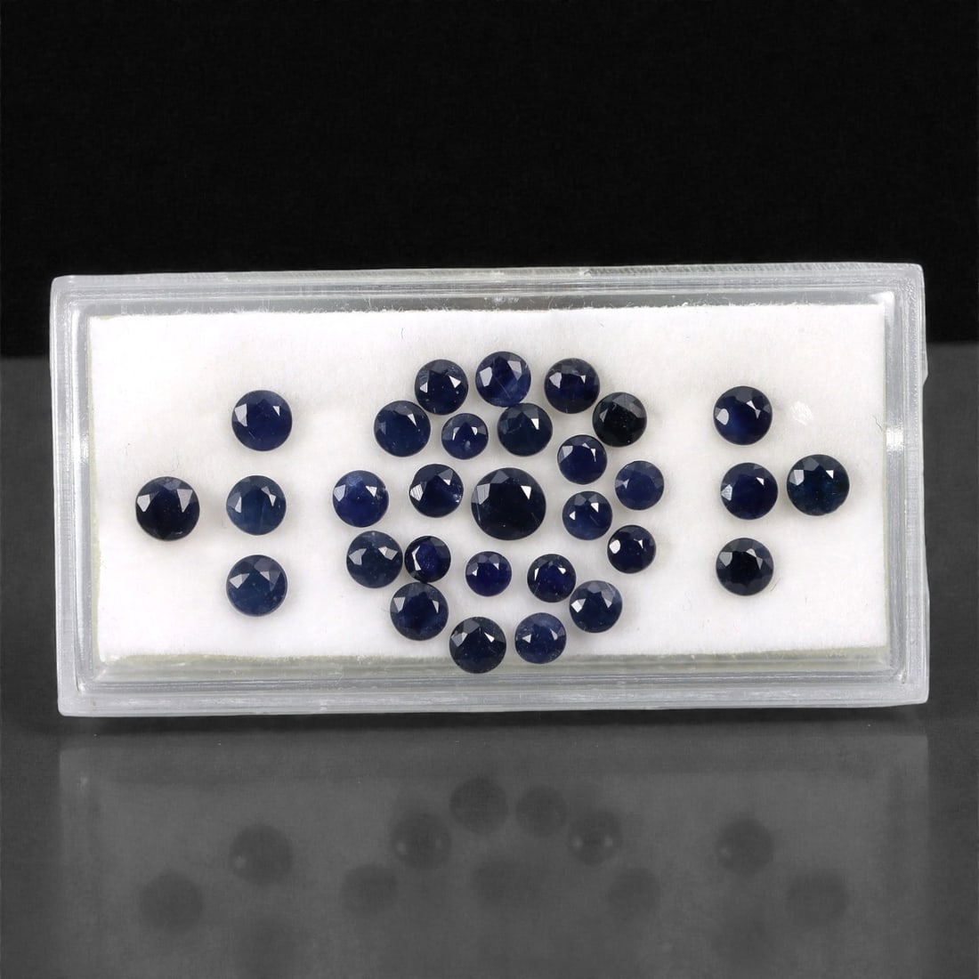 5.40 Carats Australian Blue Sapphire Parcel - Round Brilliant Cut, 64DA: This curated parcel of round brilliant-cut blue sapphires from Australia exhibits a rich, deep blue hue, reminiscent of the ocean at midnight. Each stone is precision-cut to maximize light return, cre