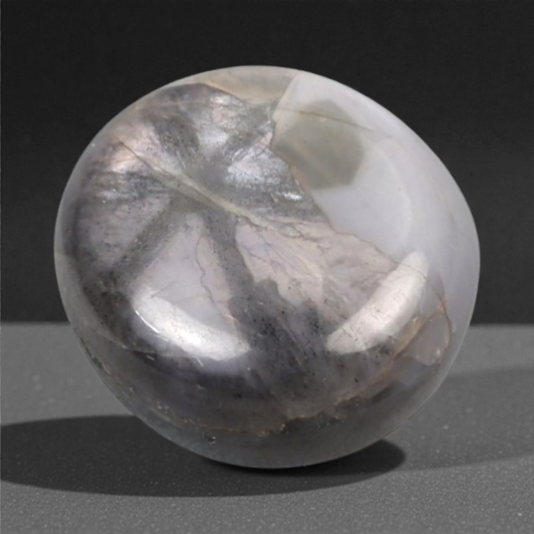 3.69 Carats Trapiche Sapphire Cabochon - Natural Burmese Stone, 351A: This exceptional round cabochon-cut trapiche sapphire from Burma exhibits a striking, milky lavender-gray hue, reminiscent of a misty dawn over a mountain lake. The stone is characterized by its natur
