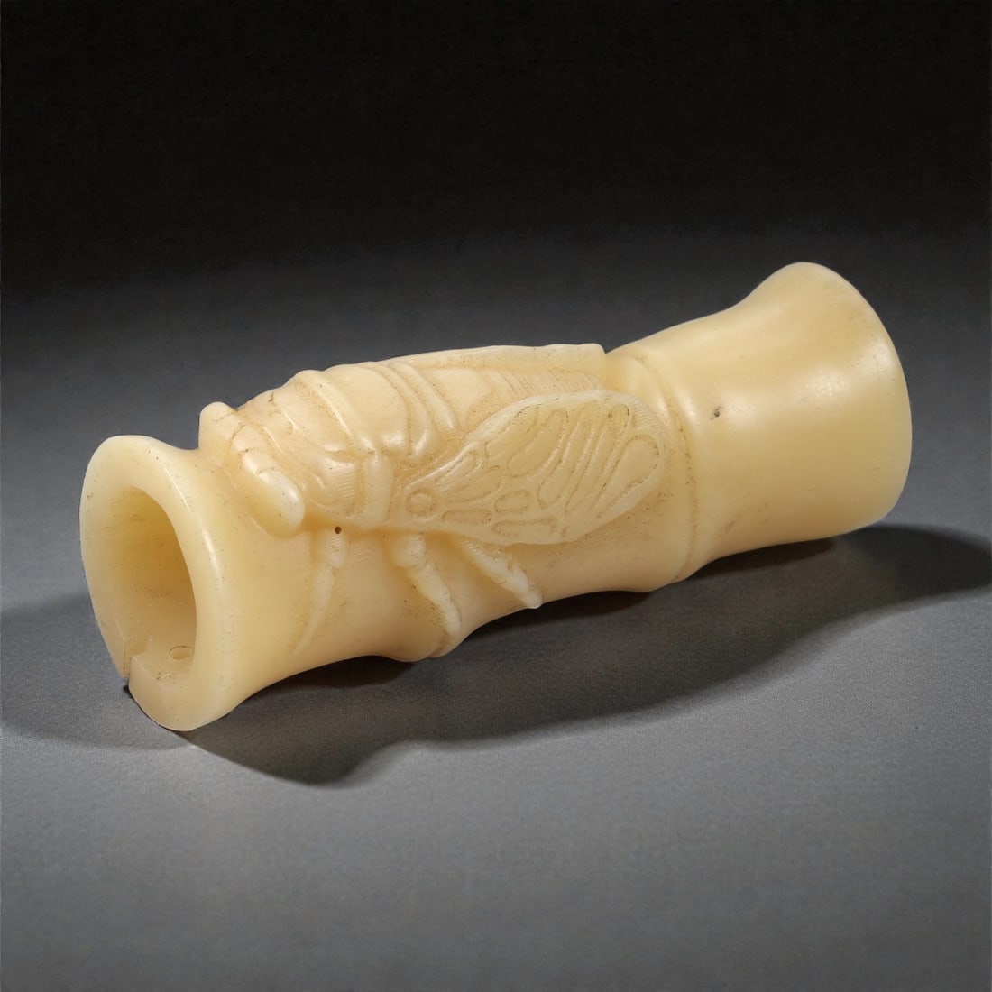 A Chinese Composite Bead Bracelet, 20th Century, 68FC: Composed of carved light-toned beads and contrasting dark spherical beads, the bracelet is assembled as a continuous strand forming a circular profile. The larger carved beads are worked with repeatin