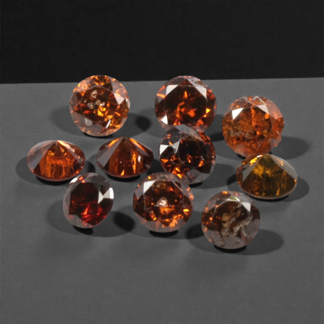 10 Pieces Irradiated Red Diamond Parcel - Round Brilliant Cut, 1.6-1.7mm, 278A: This vibrant parcel of 10 loose irradiated red diamond gems captivates with a rich, fiery red hue that evokes the intensity of a glowing ember and the warmth of a sunset. Each stone is cut in a well-p