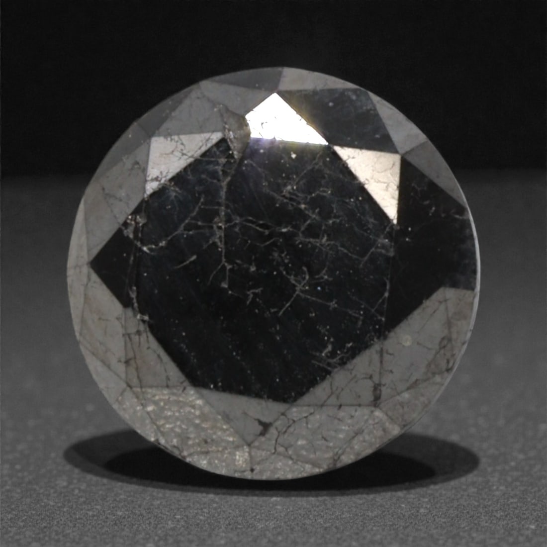 1.70 Carats Black Diamond - Round Brilliant Cut, 298A: This substantial black diamond captivates with a deep, opaque black hue that evokes the intensity of polished obsidian and the mystery of a midnight sky. Cut in a well-proportioned round brilliant sha