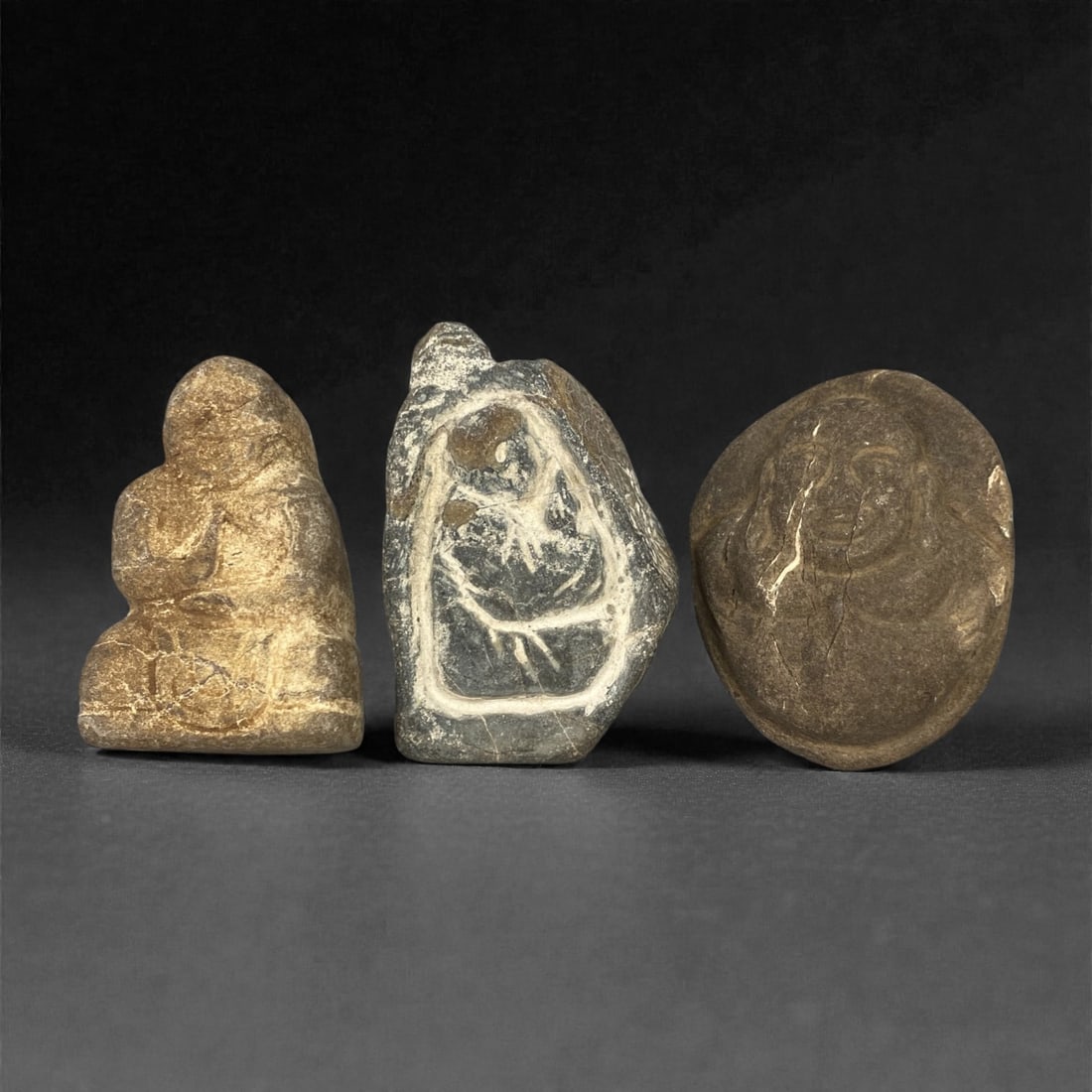 A Group of Four Christian Period Stone Carving Reliefs, 4th-7th Century, 5FN: Carved from stone with natural patination, mineral inclusions, and surface wear, the four reliefs depict distinct iconographic elements. The top-left relief is triangular, featuring a stylized floral