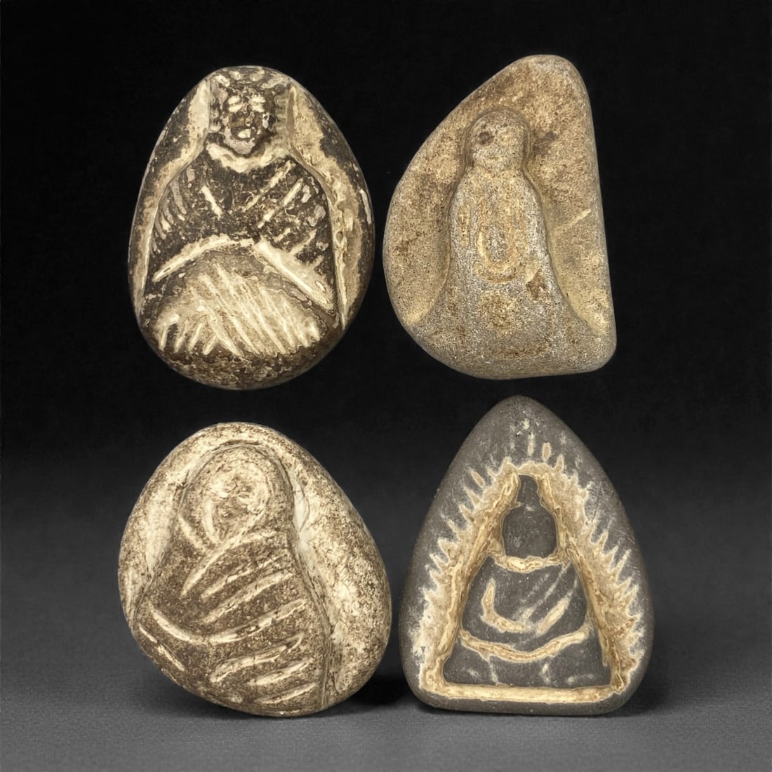 A Group of Four Edo Period Buddhist Stone Carvings, 17th-19th Century, 14FN: Carved from stone with natural tonal variation, surface wear, and mineral encrustation, the four objects depict Buddhist figures in shallow relief, set within irregular stone matrices. The top-left ca