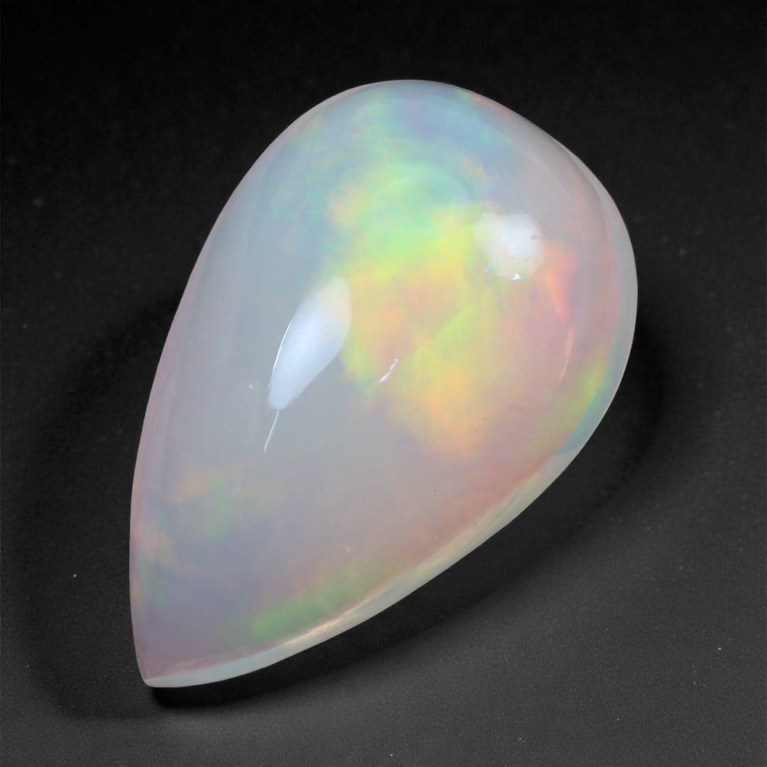 3.97 Carats Solar Bloom Welo Opal - Natural Ethiopian Gemstone 15.1x9.7x6.4mm, 41XH: A graceful blend of lemon yellow, soft amber, and mint green glows from within this luminous Welo opal, evoking the radiance of sunlight diffused through morning fog. The play-of-color is broad and pa