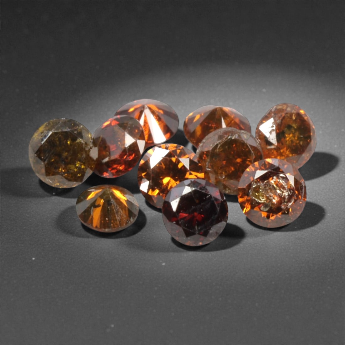 10 Pieces Irradiated Red Diamond Parcel - Round Brilliant Cut, 1.6-1.7mm, 266A: This vibrant parcel of 10 loose irradiated red diamond gems captivates with a rich, fiery red hue that evokes the intensity of a glowing ember and the warmth of a sunset. Each stone is cut in a well-p