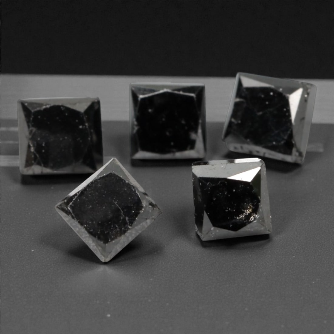 1.00 Carats Black Diamond Parcel - Princess Cut, 222A: This striking parcel of five loose black diamond gems captivates with a deep, opaque black hue that evokes the intensity of polished obsidian and the mystery of a midnight sky. Each stone is cut in a