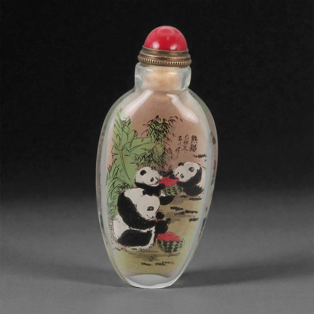 A Chinese Glass Inside-Painted Snuff Bottle, 20th Century, 56FG: The snuff bottle is formed from clear glass and of elongated ovoid form, tapering gently from the rounded shoulders to a narrow oval foot and rising to a short cylindrical neck with a flat rim. The in