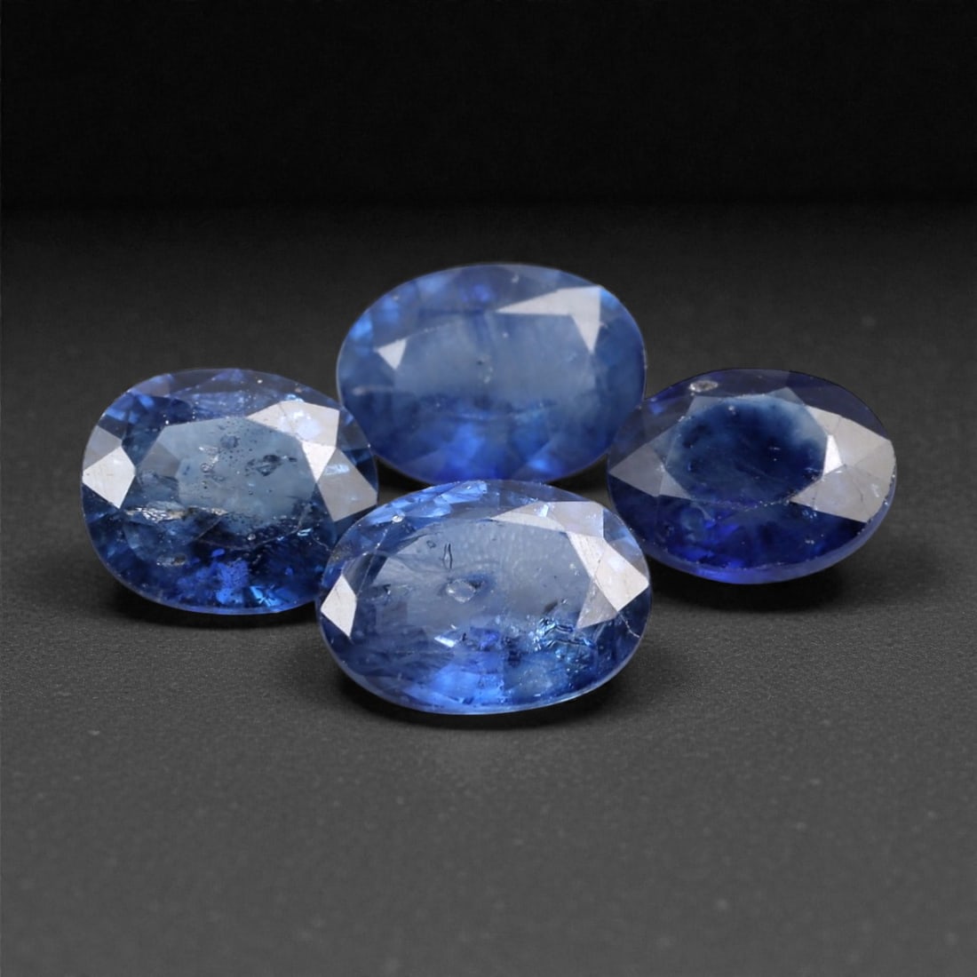 3.26 Carats Deep Blue Sapphire Parcel - Beryllium-Treated Burmese Stones, 335A: This rich parcel of four loose sapphire gems captivates with a deep, saturated blue hue that evokes the intensity of a midnight ocean and the depth of a clear night sky. Each stone is cut in a distinc