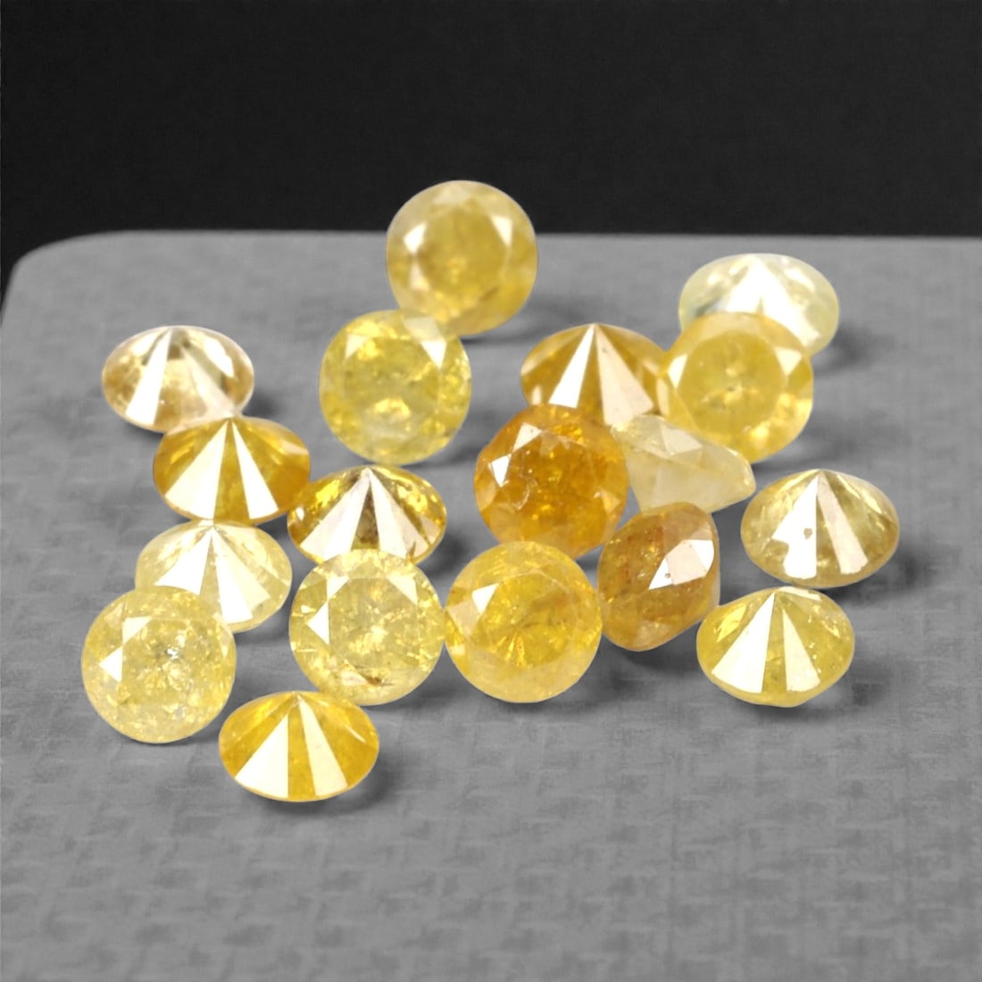 1.02 Carats Fancy Yellow Diamond Parcel - Natural African Stones, 59A: This exquisite parcel of round fancy diamonds radiates with a warm, honeyed glow, ranging from soft lemon and buttercup hues to deeper golden amber tones. Each stone is precision-cut to maximize light