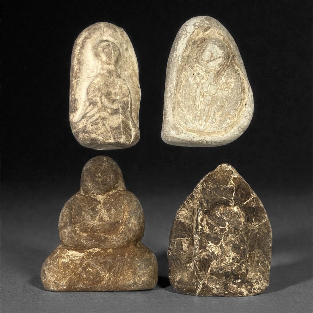 A Group of Four Edo Period Buddhist Stone Carvings, 17th-19th Century, 65FM: Comprising four stone carvings, each formed from naturally shaped or cut stone with visible surface patina and tonal variation. The top-left relief depicts a seated Buddhist figure in a meditative pos