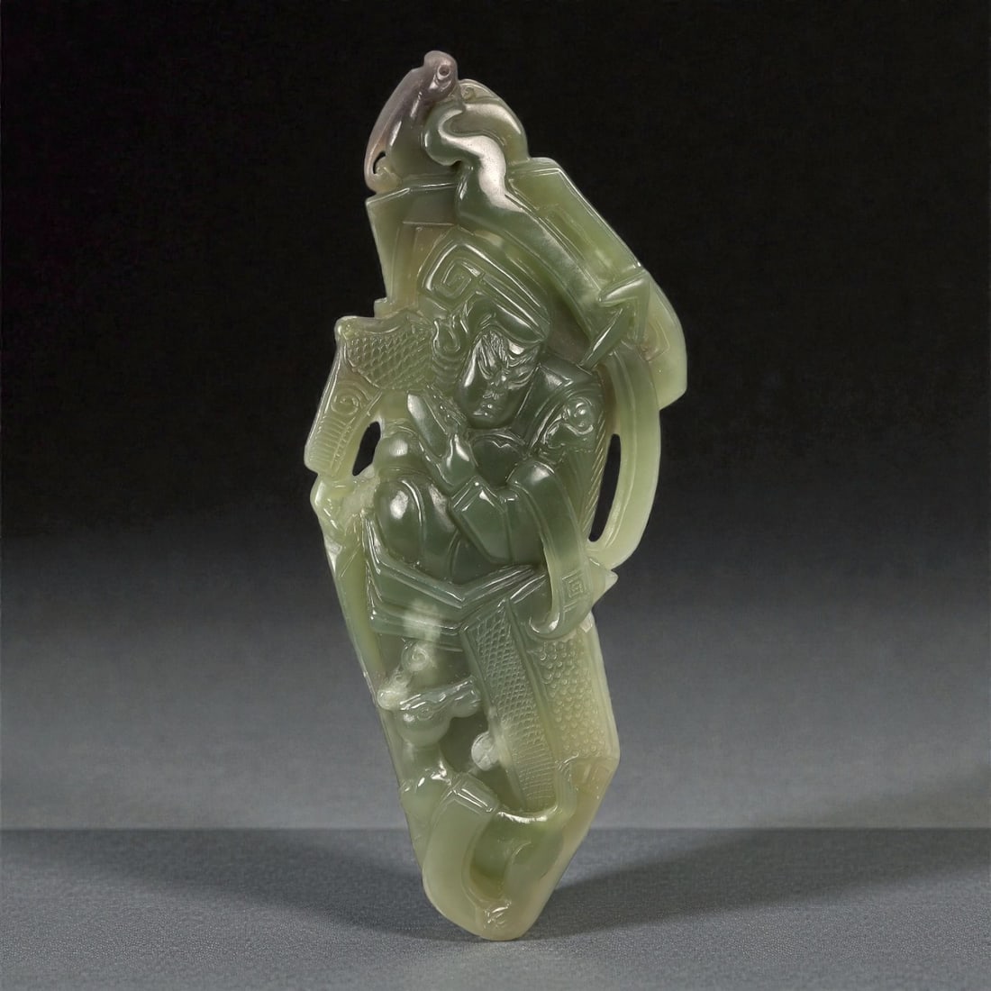 A Chinese Nephrite Jade Figural Display Carving, 20th Century, 82FC: Carved from translucent olive-green Hetian nephrite jade with subtle tonal gradation and darker inclusions, the object is worked as a vertically oriented figural composition in high relief. The figure