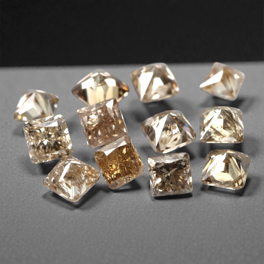 0.52ct 12 Pieces Champagne Diamond Parcel - Princess Cut, 211A: This elegant parcel of 12 loose champagne diamond gems captivates with a warm, honeyed hue that evokes the richness of aged champagne and the glow of liquid sunlight. Each stone is cut in a well-propo